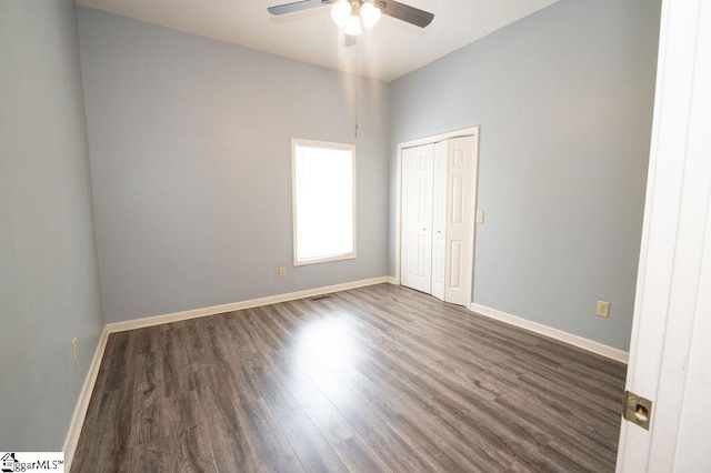 112 Garrison St, Easley, SC 29640 - unfurnished bedroom with dark wood-style flooring, a closet, and a ceiling fan