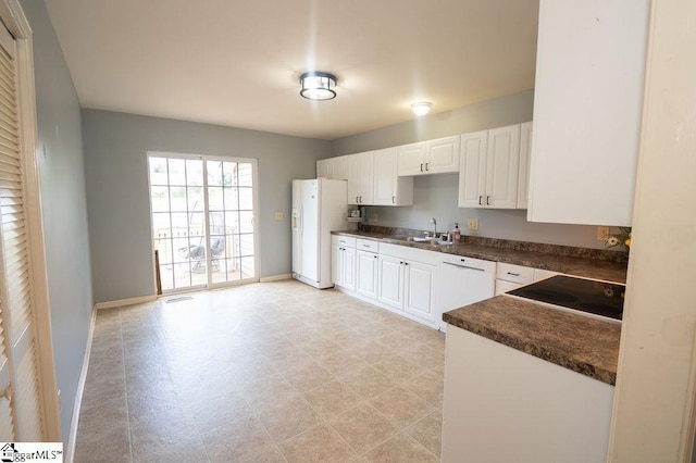 112 Garrison St, Easley, SC 29640 - kitchen featuring white appliances, dark countertops, white cabinets, and light floors