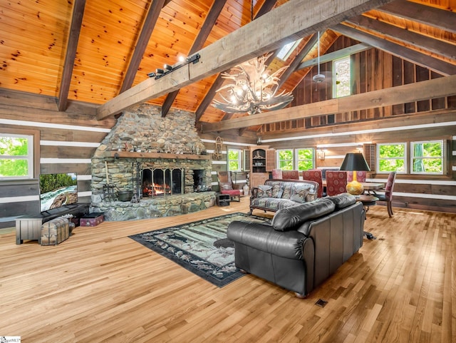 980 Mountain Forest Dr, Union Mills, NC 28167 - living room featuring a chandelier, a stone fireplace, wood walls, high vaulted ceiling, and wood-type flooring