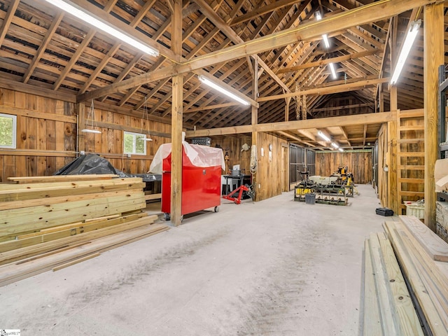 980 Mountain Forest Dr, Union Mills, NC 28167 - miscellaneous room with unfinished concrete floors, vaulted ceiling, and wood walls