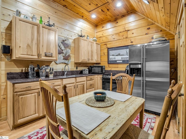980 Mountain Forest Dr, Union Mills, NC 28167 - kitchen with black appliances, wood walls, wooden ceiling, light brown cabinets, and dark countertops