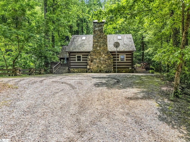 980 Mountain Forest Dr, Union Mills, NC 28167 - view of front of home featuring a deck, a chimney, a forest view, stairway, and log siding