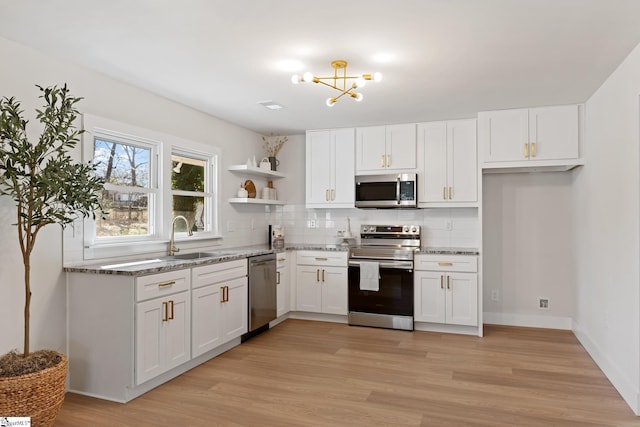 3209 Howland Dr, Anderson, SC 29626 - kitchen with appliances with stainless steel finishes, open shelves, a chandelier, and white cabinetry