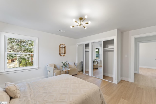 3209 Howland Dr, Anderson, SC 29626 - bedroom featuring multiple closets, a chandelier, and light wood-style flooring