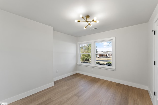 3209 Howland Dr, Anderson, SC 29626 - empty room with a chandelier and wood finished floors