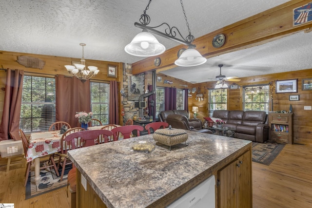 495 Pleasant Grove Rd, Pickens, SC 29671 - kitchen with wood walls, a textured ceiling, light wood-type flooring, a chandelier, and decorative light fixtures