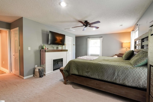 213 Quail Creek Dr, Pickens, SC 29657 - carpeted bedroom with a glass covered fireplace, multiple windows, a ceiling fan, and a textured ceiling