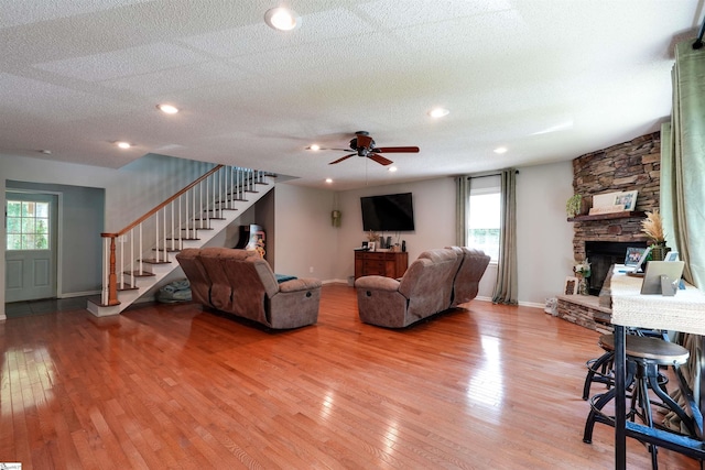 213 Quail Creek Dr, Pickens, SC 29657 - living room featuring stairway, light wood-style flooring, plenty of natural light, a ceiling fan, and a textured ceiling