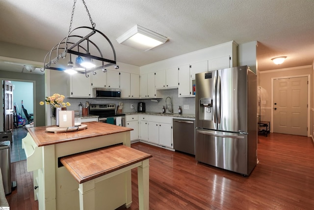 213 Quail Creek Dr, Pickens, SC 29657 - kitchen featuring appliances with stainless steel finishes, dark wood-style floors, wood counters, a textured ceiling, and white cabinetry