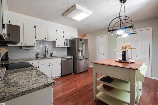 213 Quail Creek Dr, Pickens, SC 29657 - kitchen with stainless steel appliances, open shelves, white cabinetry, decorative backsplash, and dark wood finished floors