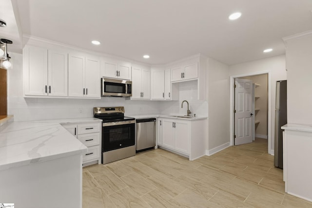 301 Thornwood Dr, Taylors, SC 29687 - kitchen with stainless steel appliances, decorative backsplash, white cabinets, recessed lighting, and light stone countertops