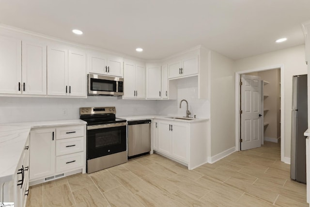 301 Thornwood Dr, Taylors, SC 29687 - kitchen featuring stainless steel appliances, white cabinetry, decorative backsplash, recessed lighting, and light stone counters