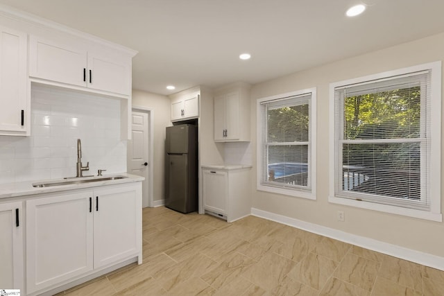 301 Thornwood Dr, Taylors, SC 29687 - kitchen with freestanding refrigerator, light countertops, tasteful backsplash, white cabinets, and recessed lighting