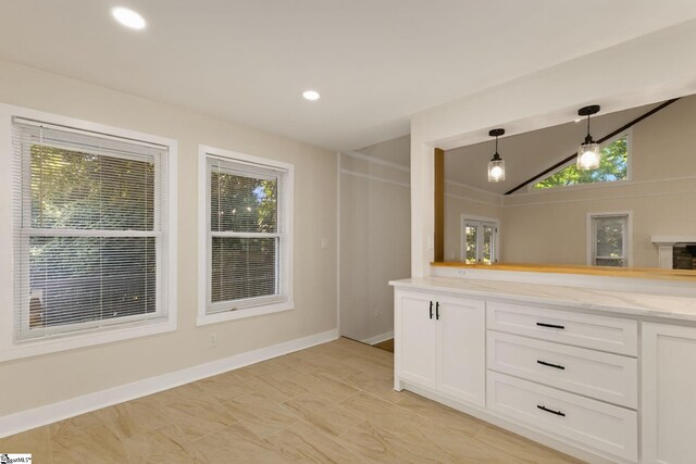 301 Thornwood Dr, Taylors, SC 29687 - kitchen with white cabinets, decorative light fixtures, vaulted ceiling, and recessed lighting