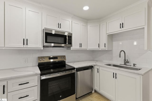 301 Thornwood Dr, Taylors, SC 29687 - kitchen featuring appliances with stainless steel finishes, white cabinetry, light stone counters, backsplash, and recessed lighting