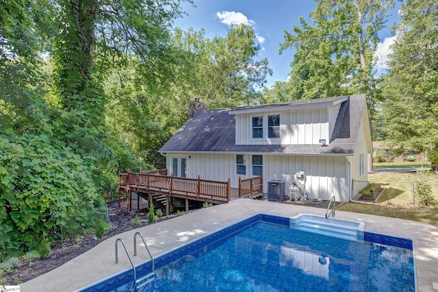301 Thornwood Dr, Taylors, SC 29687 - back of property with a wooden deck, board and batten siding, a chimney, an outdoor pool, and a shingled roof