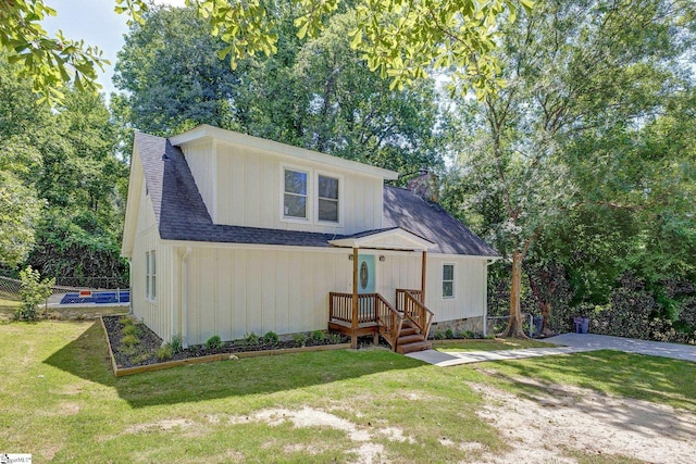 301 Thornwood Dr, Taylors, SC 29687 - view of front facade featuring a chimney, a front yard, a shingled roof, and view of scattered trees