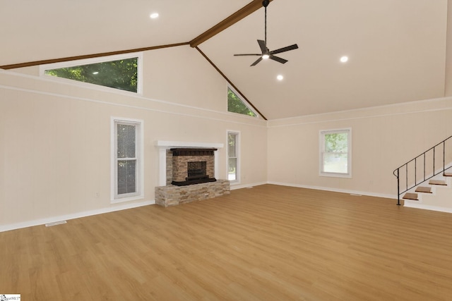 301 Thornwood Dr, Taylors, SC 29687 - unfurnished living room featuring high vaulted ceiling, light wood-style floors, a fireplace, a ceiling fan, and stairs
