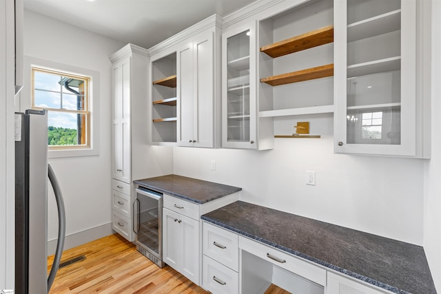621 Bascule Ridge Ln, Campobello, SC 29322 - kitchen with beverage cooler, open shelves, freestanding refrigerator, and white cabinets