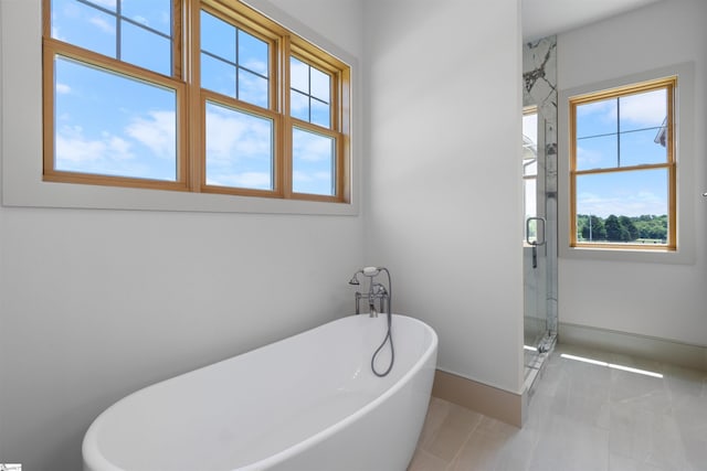 621 Bascule Ridge Ln, Campobello, SC 29322 - full bathroom featuring a freestanding tub, a stall shower, and tile patterned floors