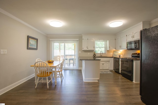 214 Cedar Cir, Easley, SC 29642 - kitchen featuring black appliances, dark countertops, crown molding, dark wood finished floors, and white cabinetry