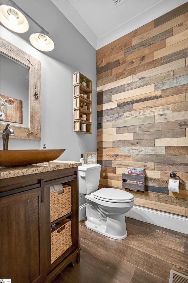 515 Herman Brooks Rd, Belton, SC 29627 - half bath featuring wood walls, vanity, and wood finished floors