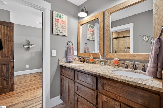 515 Herman Brooks Rd, Belton, SC 29627 - bathroom with double vanity, a stall shower, and wood finished floors