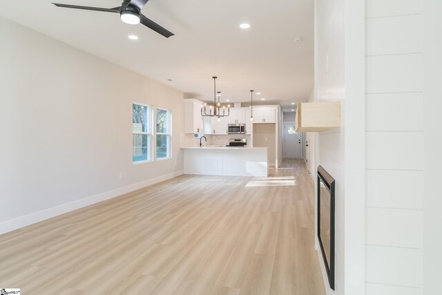 166 Dunbar St, Wellford, SC 29385 - unfurnished living room with recessed lighting, ceiling fan, light wood finished floors, and a chandelier
