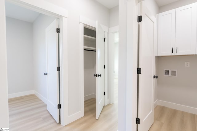166 Dunbar St, Wellford, SC 29385 - washroom with light wood-style floors, washer hookup, and cabinet space
