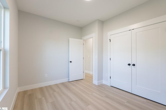 166 Dunbar St, Wellford, SC 29385 - unfurnished bedroom with light wood finished floors and a closet