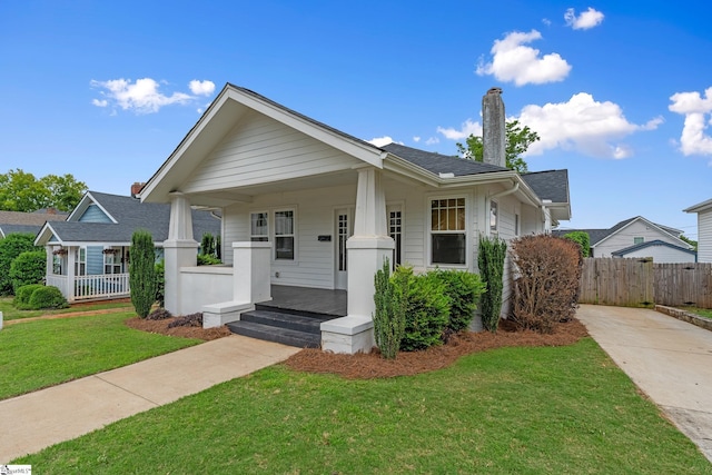 521 Anderson St, Greenville, SC 29601 - bungalow-style home with a porch, a chimney, and concrete driveway