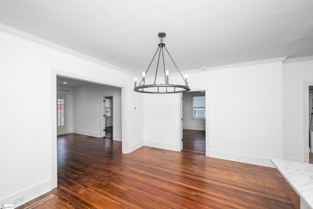 521 Anderson St, Greenville, SC 29601 - unfurnished dining area with a chandelier, ornamental molding, plenty of natural light, and wood finished floors