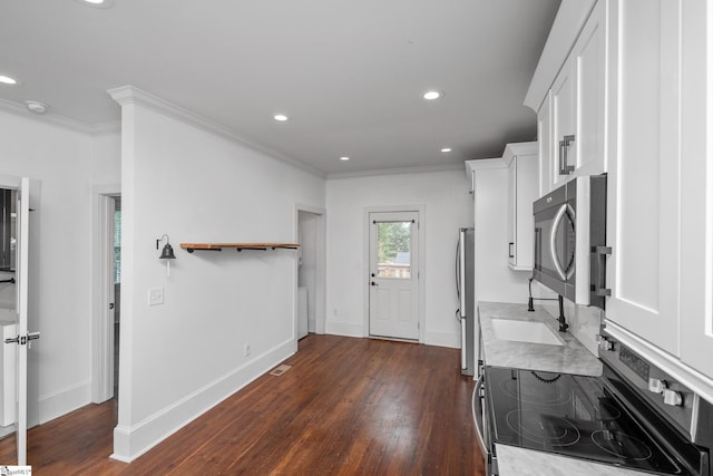 521 Anderson St, Greenville, SC 29601 - kitchen featuring appliances with stainless steel finishes, white cabinetry, dark wood-style flooring, light countertops, and recessed lighting