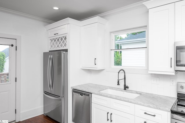 521 Anderson St, Greenville, SC 29601 - kitchen with appliances with stainless steel finishes, ornamental molding, light stone countertops, white cabinetry, and recessed lighting