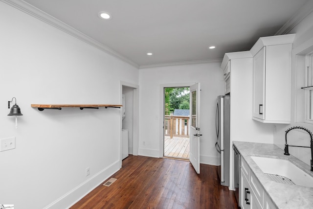 521 Anderson St, Greenville, SC 29601 - kitchen featuring white cabinetry, dark wood finished floors, appliances with stainless steel finishes, recessed lighting, and ornamental molding