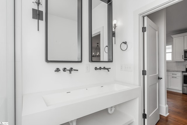 521 Anderson St, Greenville, SC 29601 - bathroom with decorative backsplash, vanity, and wood finished floors