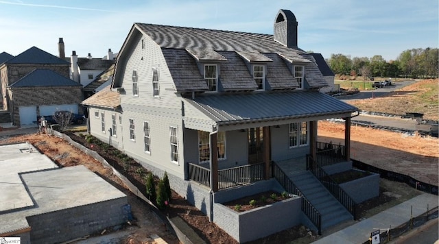 404 Odell St, Greenville, SC 29615 - back of house featuring covered porch, a chimney, a metal roof, and a standing seam roof