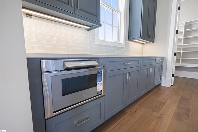 404 Odell St, Greenville, SC 29615 - kitchen with oven, dark wood-style flooring, decorative backsplash, and light countertops