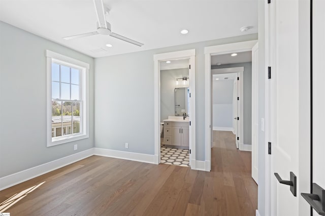 404 Odell St, Greenville, SC 29615 - unfurnished bedroom featuring wood finished floors, recessed lighting, a ceiling fan, and connected bathroom