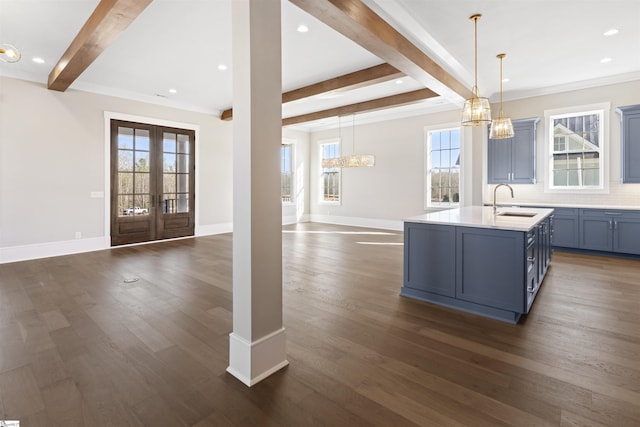 404 Odell St, Greenville, SC 29615 - kitchen featuring open floor plan, beamed ceiling, dark wood-style flooring, an island with sink, and light countertops