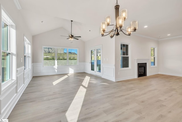 140 Mimosa Rd Lot 27, Inman, SC 29349 - unfurnished living room with healthy amount of natural light, a chandelier, light wood-style flooring, a glass covered fireplace, and a wainscoted wall