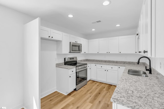 2 Melbourne Ln, Greenville, SC 29615 - kitchen featuring stainless steel appliances, light wood-type flooring, recessed lighting, white cabinets, and light stone countertops