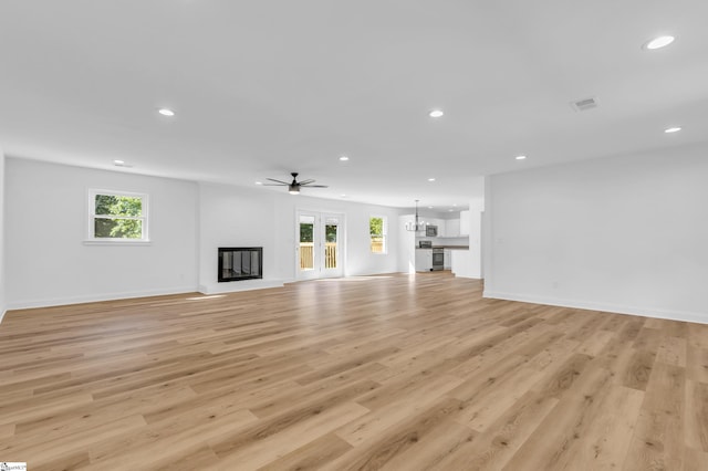 2 Melbourne Ln, Greenville, SC 29615 - unfurnished living room with a glass covered fireplace, recessed lighting, light wood-style floors, and a ceiling fan