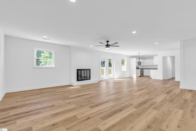 2 Melbourne Ln, Greenville, SC 29615 - unfurnished living room featuring recessed lighting, plenty of natural light, ceiling fan, light wood-style floors, and a fireplace