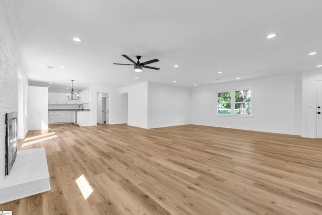 2 Melbourne Ln, Greenville, SC 29615 - unfurnished living room featuring recessed lighting, a ceiling fan, light wood-style flooring, a chandelier, and a fireplace