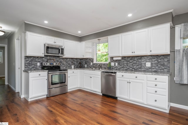 101 Havendale Dr, Fountain Inn, SC 29644 - kitchen with stainless steel appliances, dark wood-style floors, white cabinetry, decorative backsplash, and ornamental molding