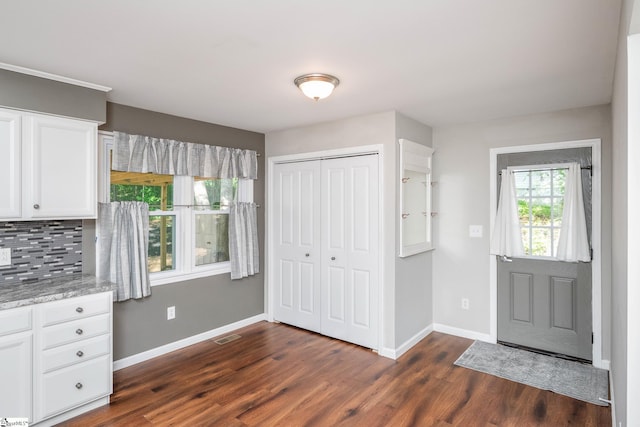 101 Havendale Dr, Fountain Inn, SC 29644 - kitchen featuring white cabinets, dark wood finished floors, backsplash, and light stone countertops