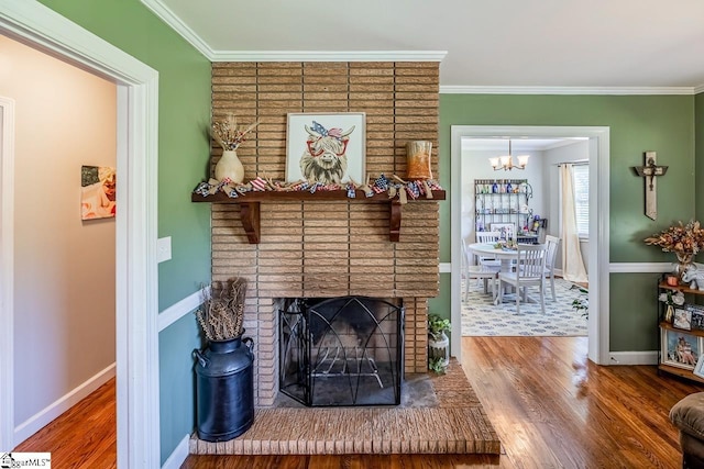 849 Harvey Rd, Greer, SC 29651 - living room with wood finished floors, a chandelier, crown molding, and a brick fireplace