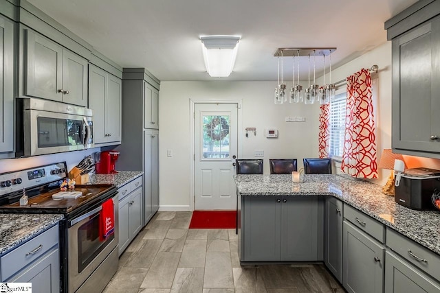 849 Harvey Rd, Greer, SC 29651 - kitchen featuring stainless steel appliances, plenty of natural light, a peninsula, and gray cabinets