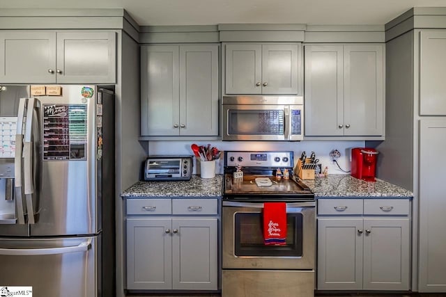 849 Harvey Rd, Greer, SC 29651 - kitchen with appliances with stainless steel finishes, gray cabinets, and stone counters